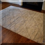 DR04. Rug with linear design.  Meaures approx. 9'x 6' 